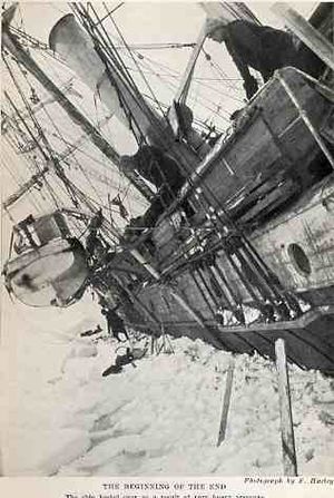  Side of a wooden steamship held in solid ice, leaning heavily to the left with a lfeboat swinging in its davits. One man visible on the ice, another aboard the ship, looking down.